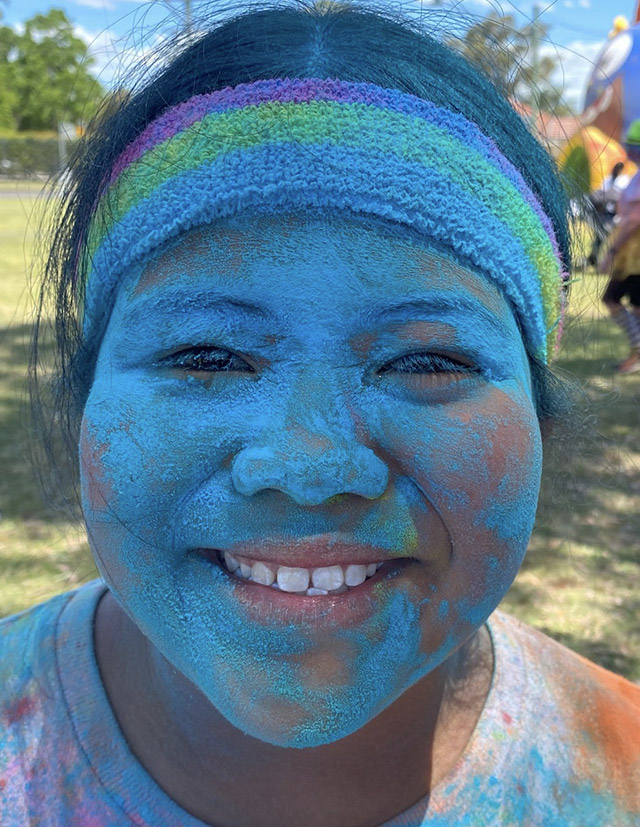 Student with powdered face following colour fun run at St Aidan's Catholic Primary School Rooty Hill