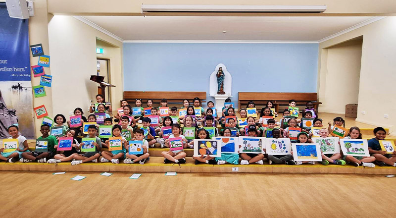 Students inside St Aidan's Catholic Primary School Rooty Hill school hall