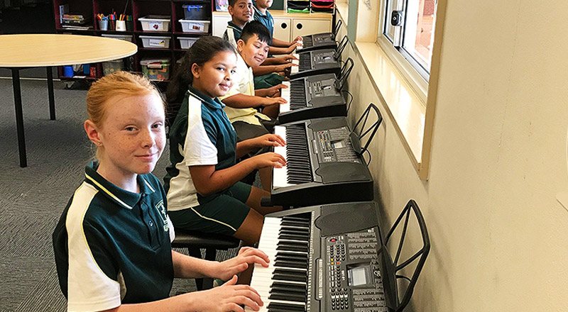 Students playing piano at St Aidan's Catholic Primary School Rooty Hill