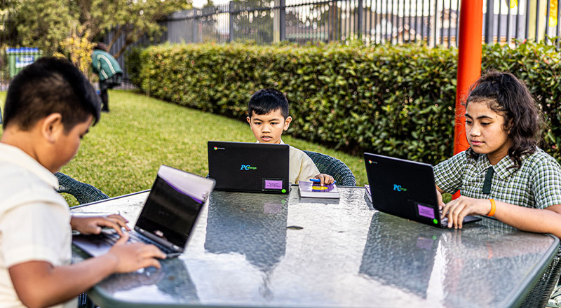 Students on exterior table at St Aidan's Catholic Primary School Rooty Hill