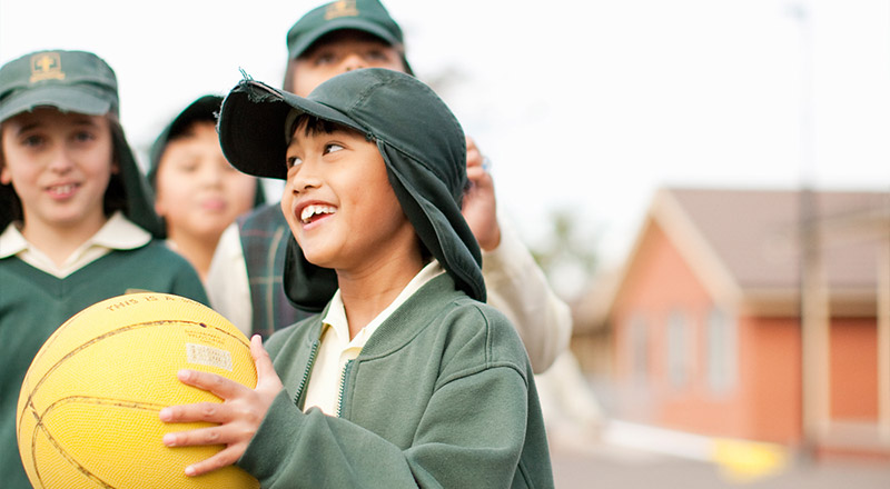 Student from St Aidan's Catholic Primary School Rooty Hill in the early 2000's holding a basketball