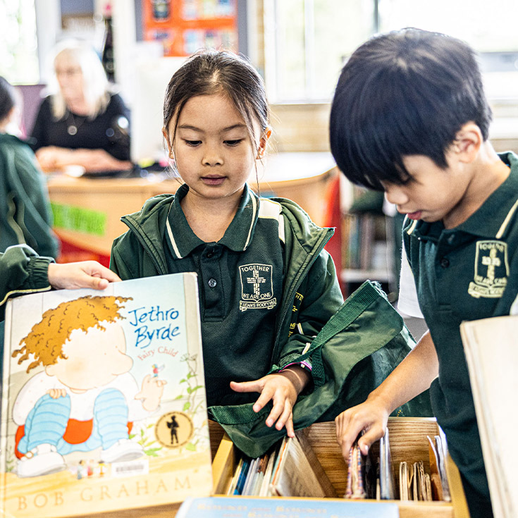 Student borrowing book from St Aidan's Catholic Primary School Rooty Hill library