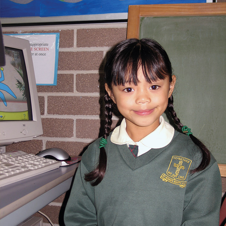 Student from early 2000's near desktop at St Aidan's Catholic Primary School Rooty Hill