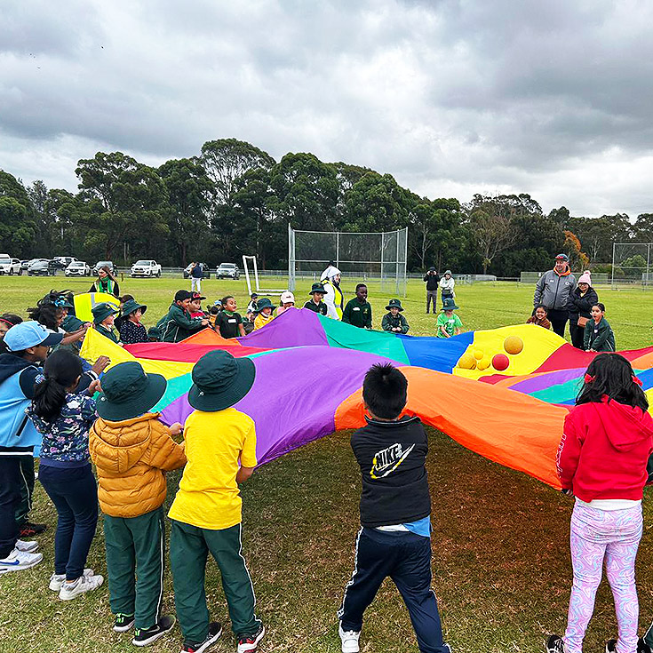 Students with rainbow parachute at St Aidan's Catholic Primary School Rooty Hill